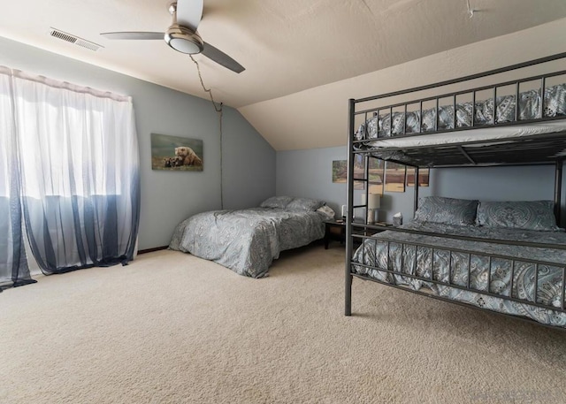 carpeted bedroom with vaulted ceiling and ceiling fan