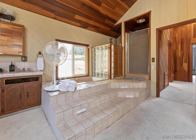 bathroom with vanity, separate shower and tub, and lofted ceiling with beams