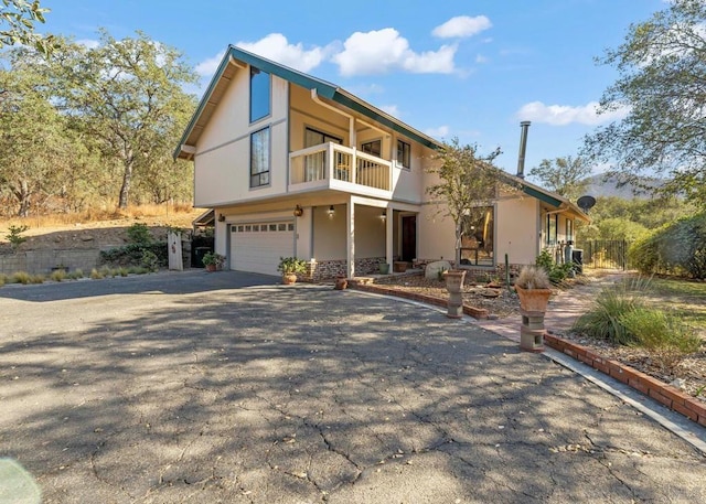 view of front of property with a balcony and a garage