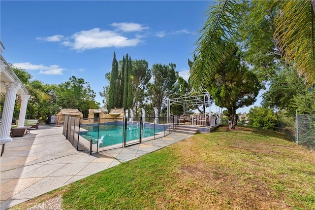 view of pool featuring a yard and a patio area