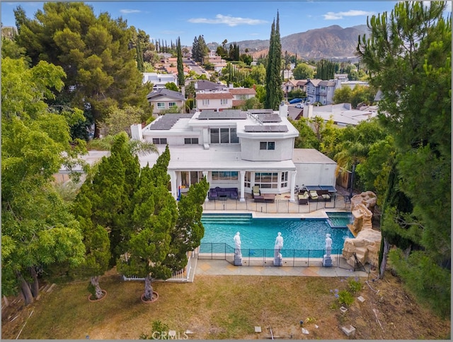 view of swimming pool with a patio and a mountain view