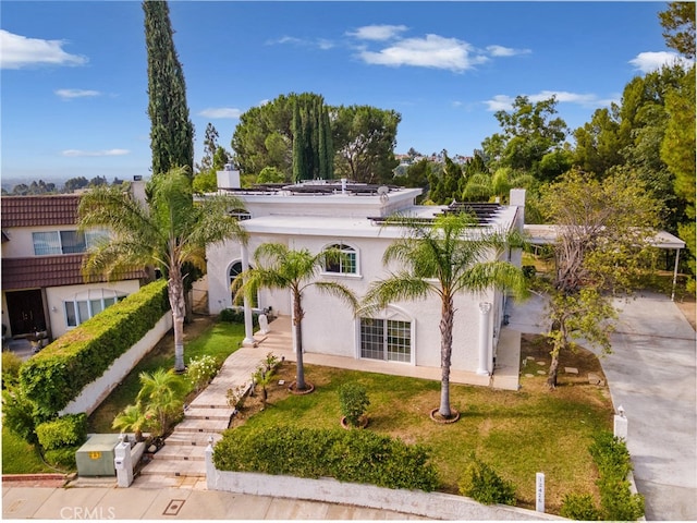 mediterranean / spanish house featuring a front lawn