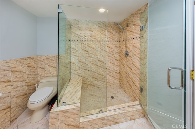 bathroom featuring tile walls, walk in shower, tile patterned floors, and toilet