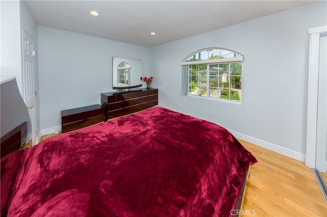 bedroom with hardwood / wood-style flooring