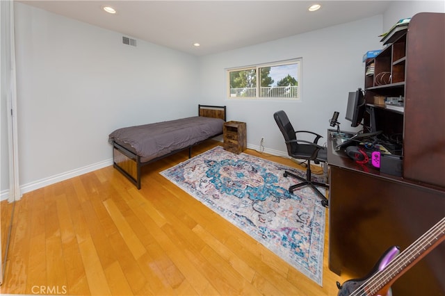 bedroom with wood-type flooring