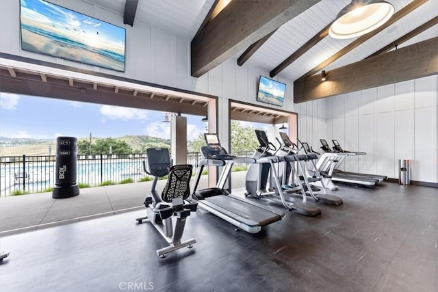 gym featuring high vaulted ceiling and a water and mountain view