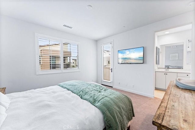 carpeted bedroom featuring ensuite bathroom