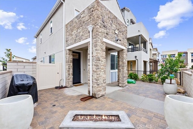 view of patio featuring a grill and an outdoor fire pit