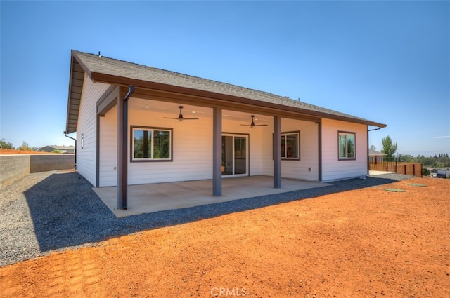 back of property with ceiling fan and a patio area