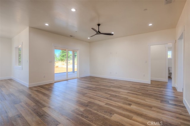 spare room with ceiling fan and hardwood / wood-style flooring