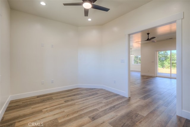 empty room with ceiling fan and hardwood / wood-style flooring