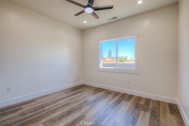 unfurnished room with ceiling fan and hardwood / wood-style flooring