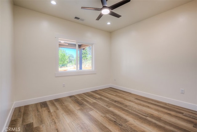 spare room featuring ceiling fan and hardwood / wood-style floors