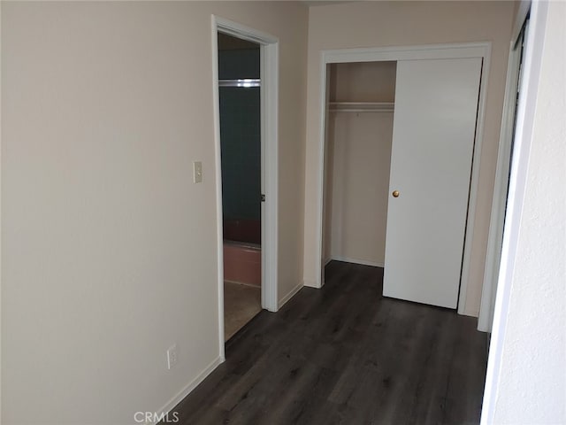 corridor with dark hardwood / wood-style floors