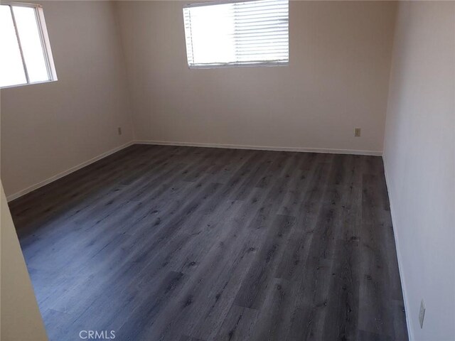 unfurnished room with dark hardwood / wood-style floors