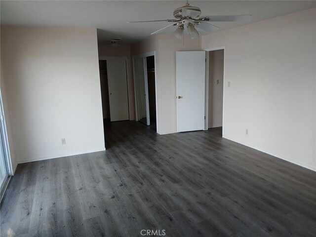 spare room with dark wood-type flooring and ceiling fan