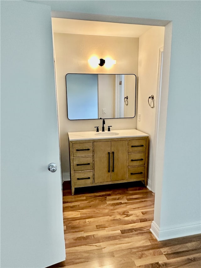 bathroom with hardwood / wood-style flooring and vanity