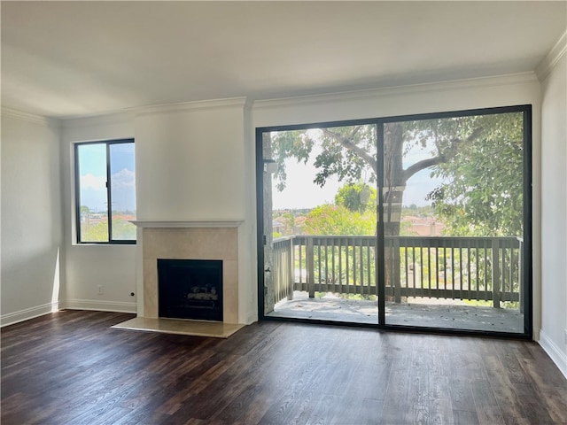 unfurnished living room featuring ornamental molding, dark wood-type flooring, and a premium fireplace