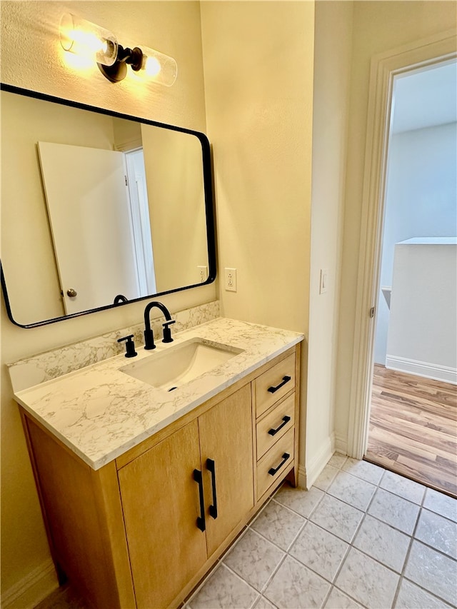 bathroom with wood-type flooring and vanity