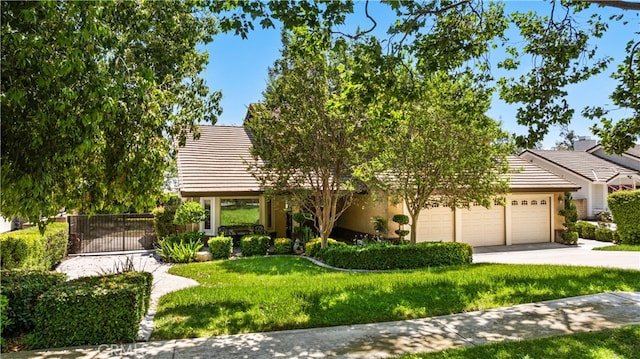 view of property hidden behind natural elements featuring a front lawn and a garage