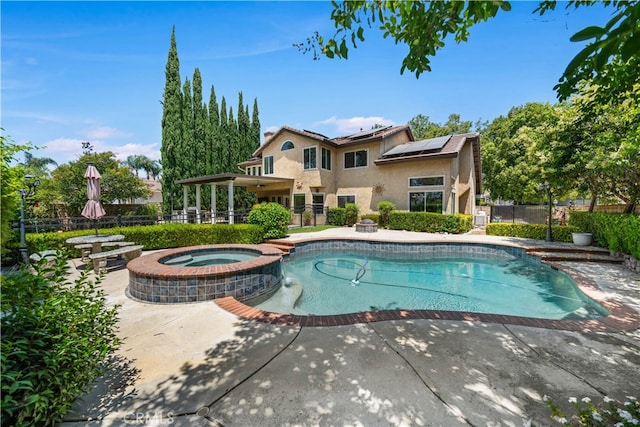 view of pool featuring a patio and an in ground hot tub