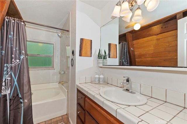 bathroom featuring vanity, a notable chandelier, and shower / tub combo