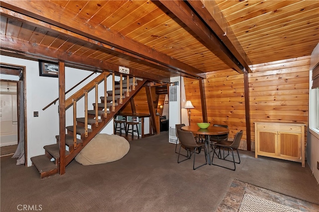 unfurnished dining area featuring beam ceiling, wooden ceiling, and carpet