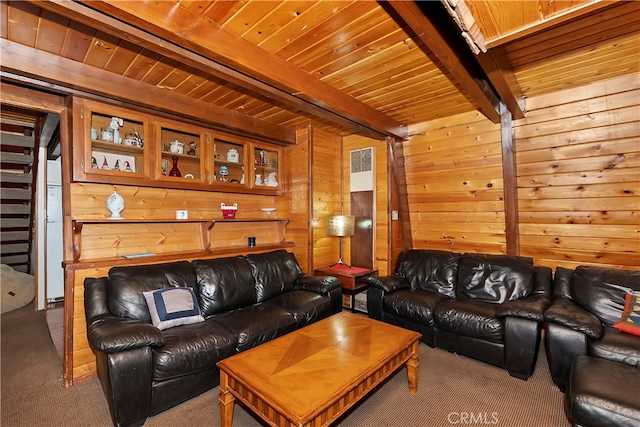 living room featuring wood walls, wooden ceiling, beamed ceiling, and carpet flooring