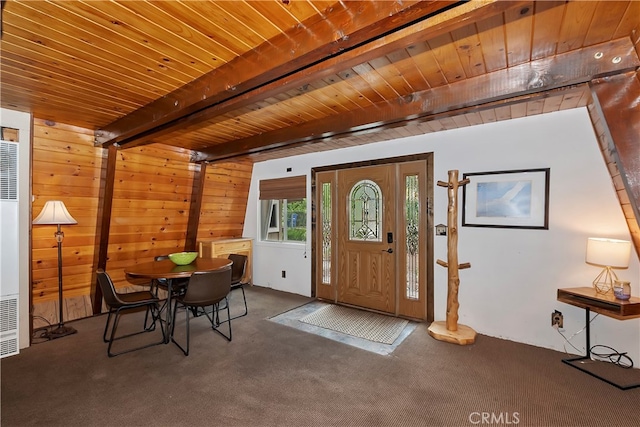 entryway featuring beam ceiling, carpet, and wood ceiling