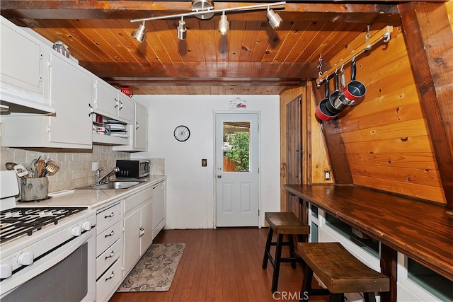 kitchen featuring tasteful backsplash, white cabinetry, dark wood-type flooring, sink, and white appliances