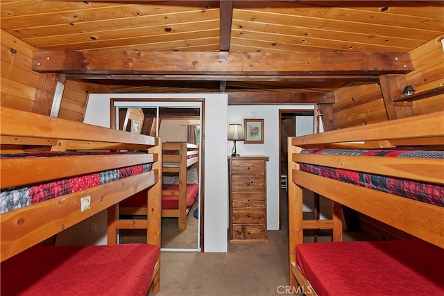 bedroom with wood ceiling, carpet flooring, vaulted ceiling, wood walls, and a closet