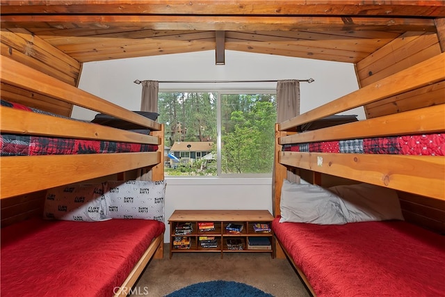 carpeted bedroom with wood ceiling and lofted ceiling with beams