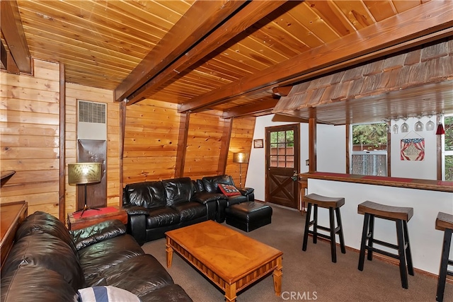 carpeted living room featuring beamed ceiling, wooden walls, and wooden ceiling