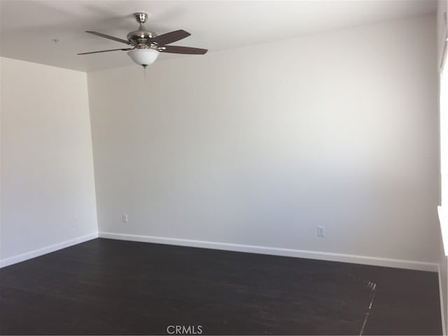 unfurnished room with ceiling fan and dark hardwood / wood-style flooring