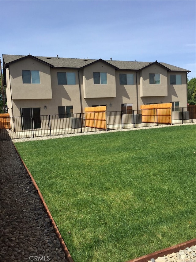 rear view of house featuring a yard