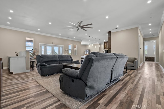 living room featuring crown molding, french doors, ceiling fan, and wood-type flooring