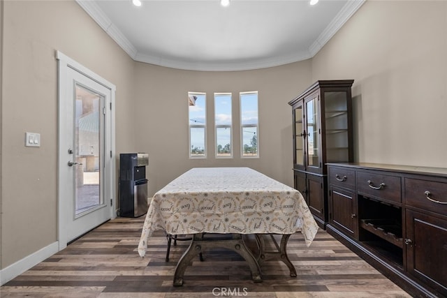 dining space featuring dark hardwood / wood-style flooring and crown molding