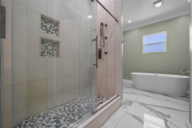 bathroom with ornamental molding and shower with separate bathtub