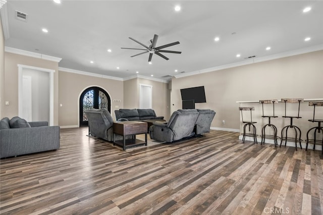 living room featuring ceiling fan, french doors, ornamental molding, and hardwood / wood-style flooring