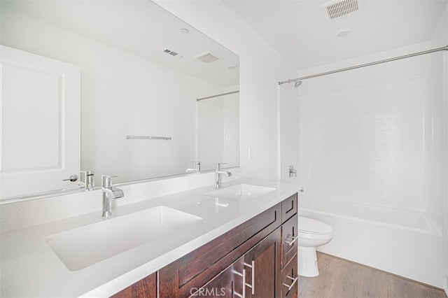 full bathroom with shower / bath combination, hardwood / wood-style flooring, toilet, and vanity