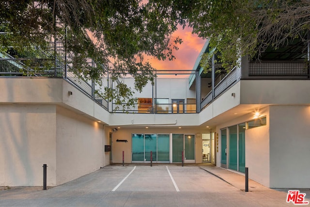 back house at dusk with a balcony