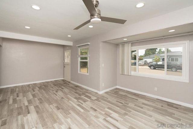 empty room featuring light wood-type flooring and ceiling fan