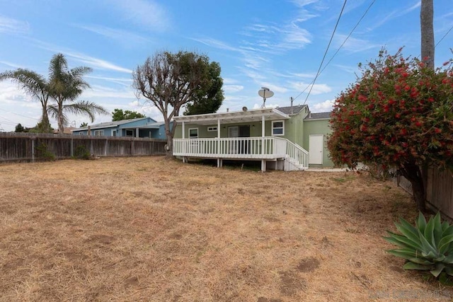 rear view of house featuring a wooden deck