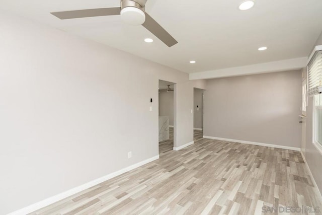 unfurnished room featuring ceiling fan and light wood-type flooring