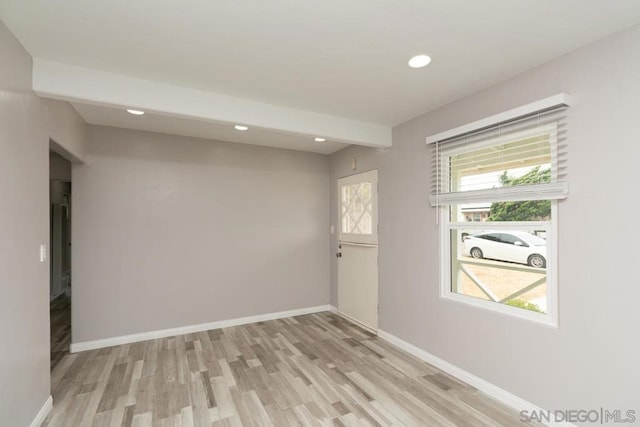 unfurnished room with light wood-type flooring