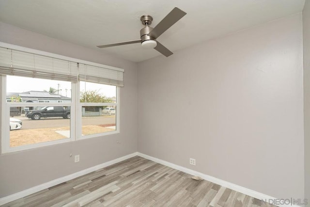 empty room featuring ceiling fan and light hardwood / wood-style flooring