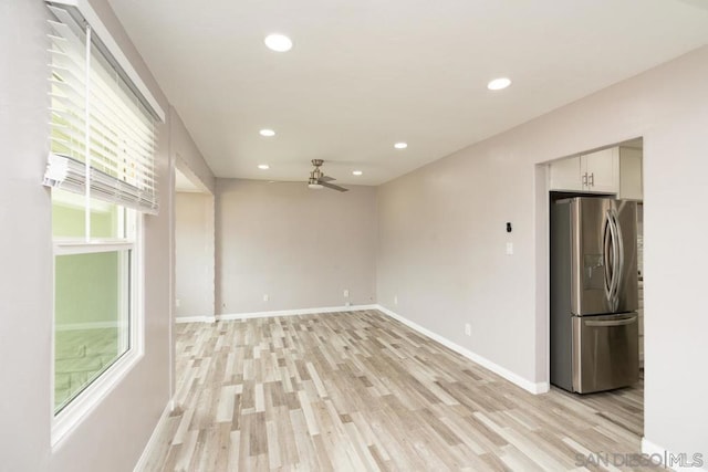 unfurnished room featuring ceiling fan and light wood-type flooring