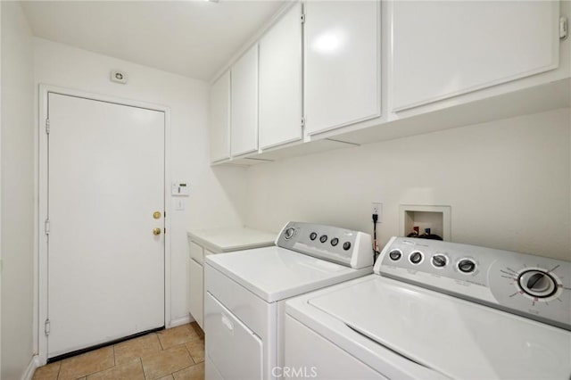 washroom featuring cabinets, separate washer and dryer, and light tile patterned floors