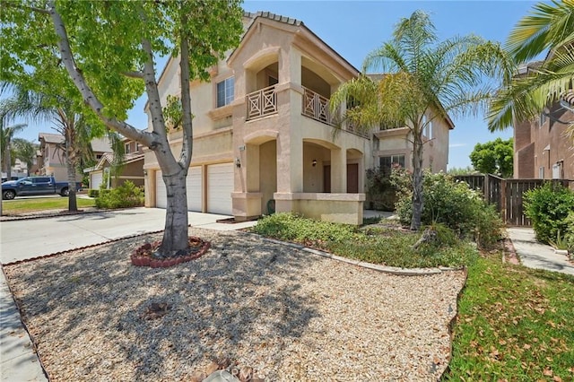 mediterranean / spanish-style house featuring a balcony and a garage