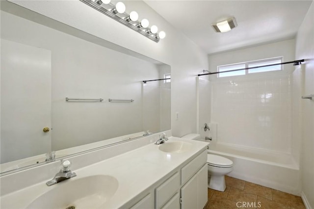 full bathroom with tile patterned flooring, vanity, washtub / shower combination, and toilet